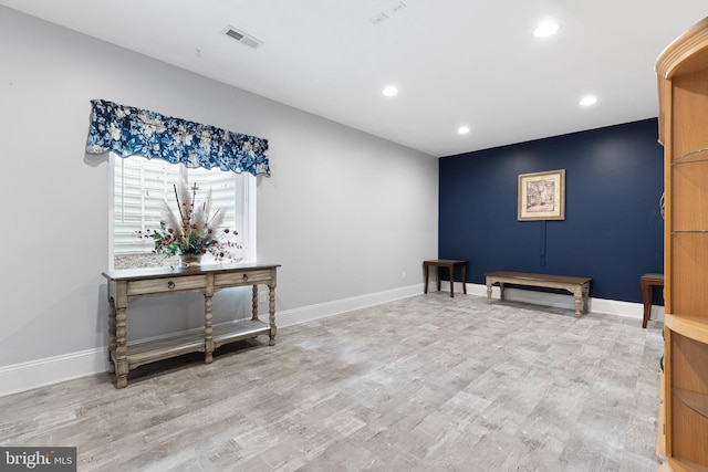 living area with recessed lighting, baseboards, and wood finished floors