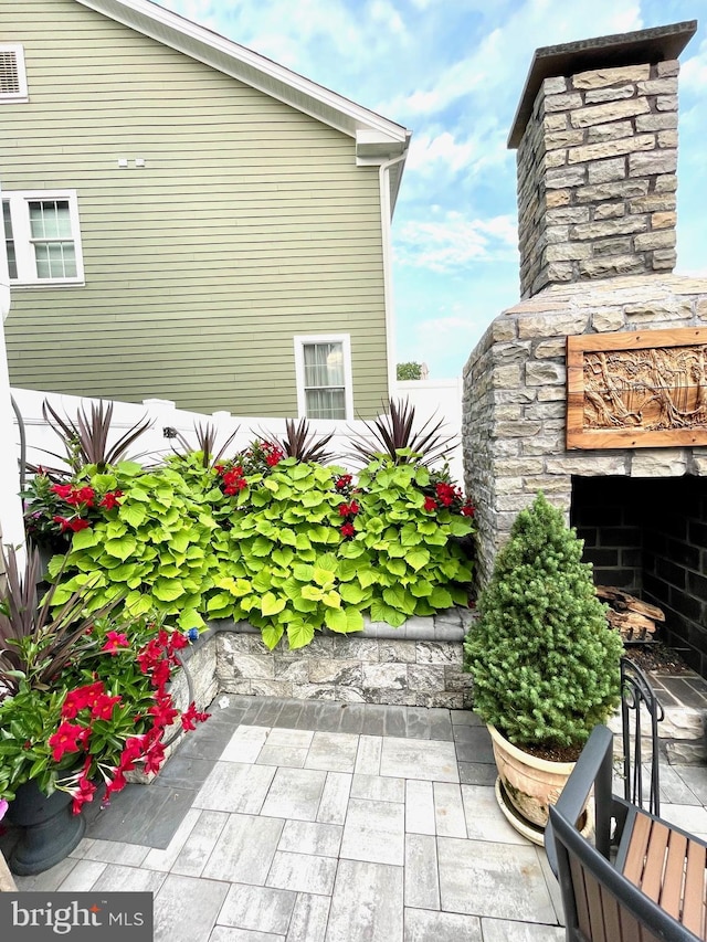 view of patio / terrace featuring an outdoor stone fireplace