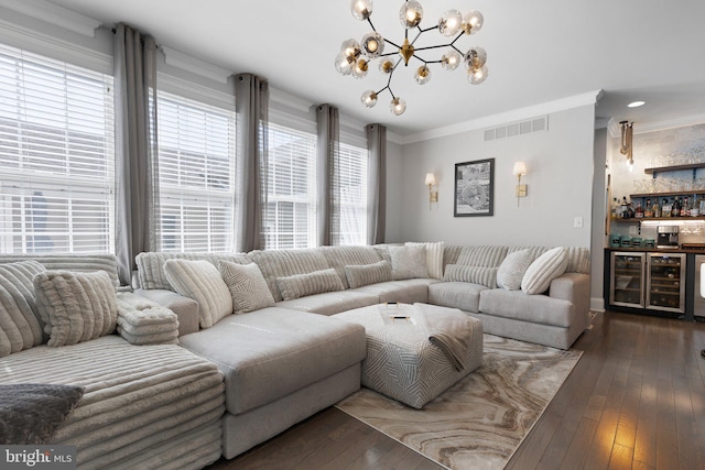 living room featuring visible vents, a bar, crown molding, and wood-type flooring