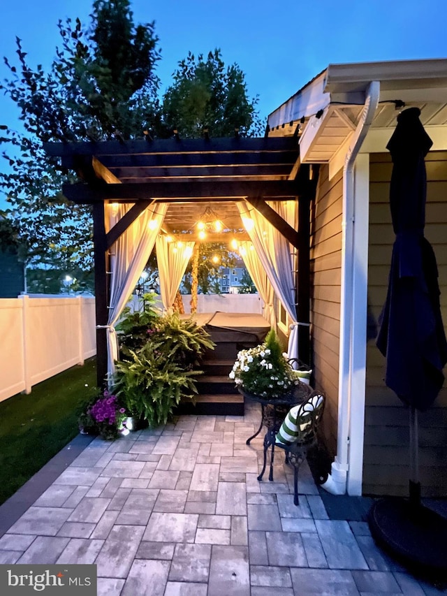 view of patio / terrace featuring fence and a pergola