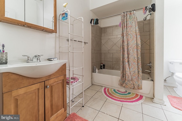 full bathroom featuring vanity, tile patterned floors, toilet, and shower / bath combo with shower curtain