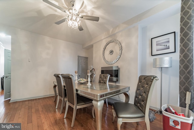 dining area with baseboards, wood-type flooring, and a ceiling fan