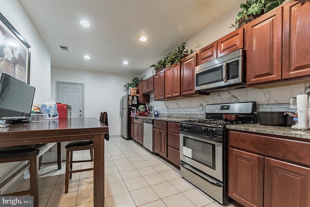 kitchen featuring light tile patterned floors, visible vents, recessed lighting, stainless steel appliances, and backsplash