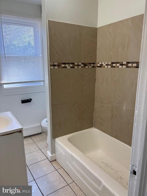 full bathroom featuring a baseboard heating unit, toilet, shower / tub combination, tile patterned floors, and vanity