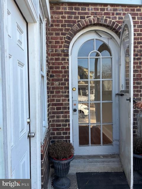 entrance to property with brick siding