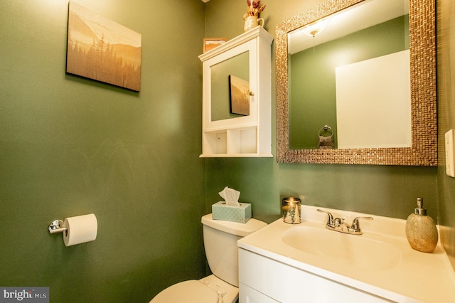 bathroom featuring toilet and vanity