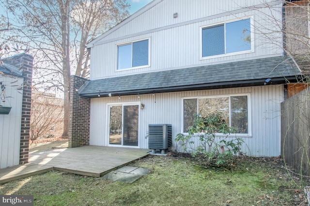 rear view of property with a deck, central AC, and roof with shingles