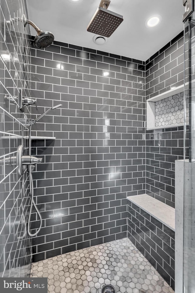 full bathroom with a tile shower