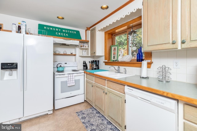 kitchen with backsplash, white appliances, light countertops, and a sink