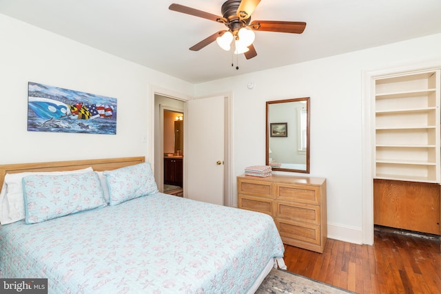 bedroom featuring baseboards, wood finished floors, and a ceiling fan