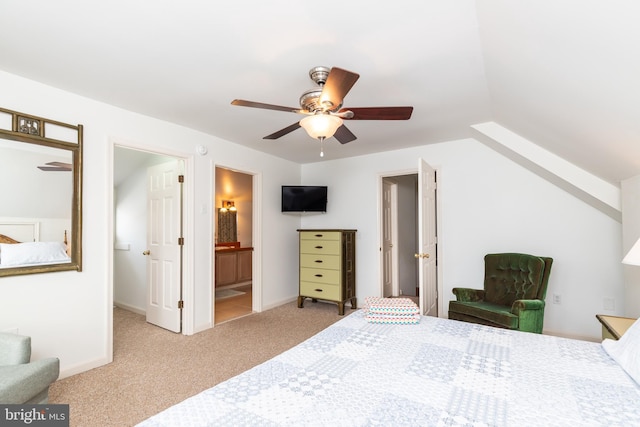 carpeted bedroom featuring ensuite bath, a ceiling fan, and baseboards