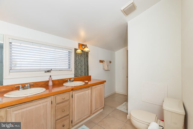 bathroom featuring a sink, visible vents, toilet, and tile patterned floors