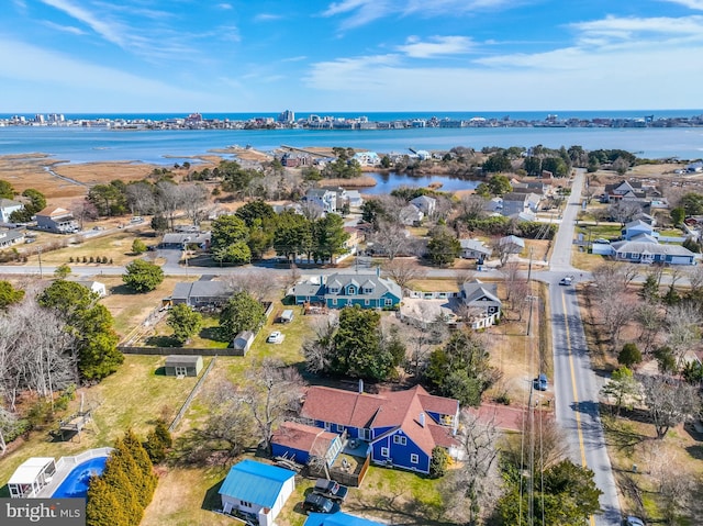 birds eye view of property with a water view and a residential view