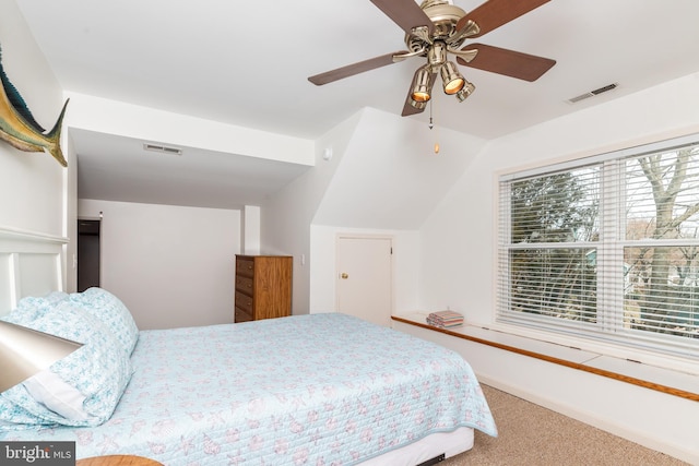 carpeted bedroom with multiple windows, a ceiling fan, and visible vents