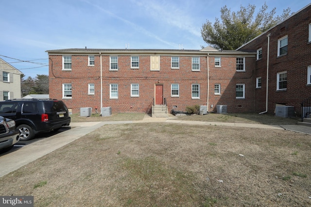 view of building exterior featuring central AC unit and entry steps