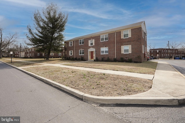 view of front of property featuring brick siding and crawl space