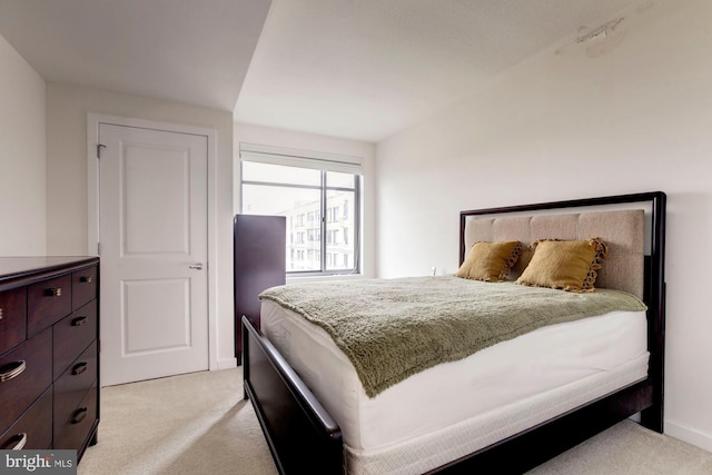 bedroom featuring light carpet