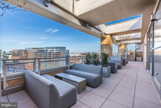 view of patio with a balcony and a city view