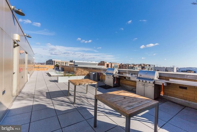 view of patio featuring a city view and a grill