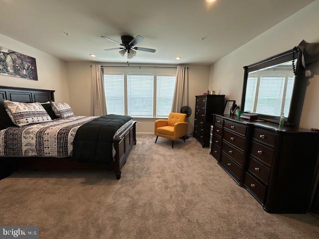 bedroom with light carpet and ceiling fan