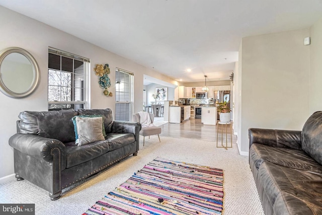 living room with light colored carpet and baseboards