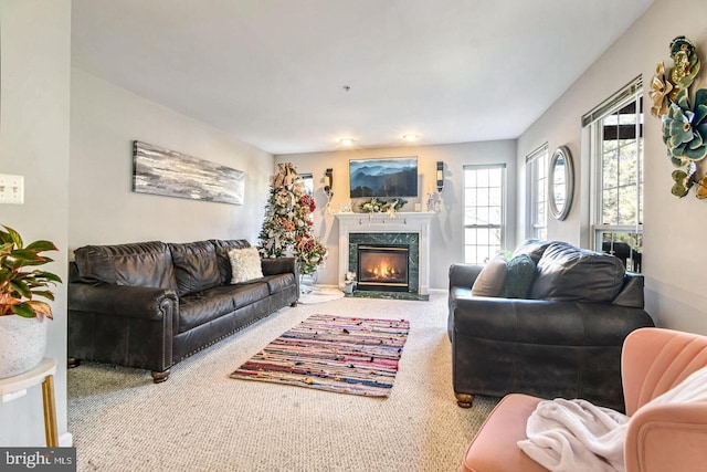 carpeted living area featuring a high end fireplace