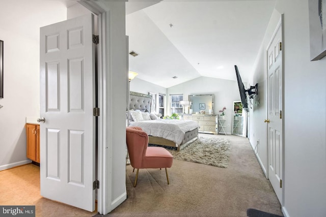 bedroom with light carpet, visible vents, baseboards, and lofted ceiling