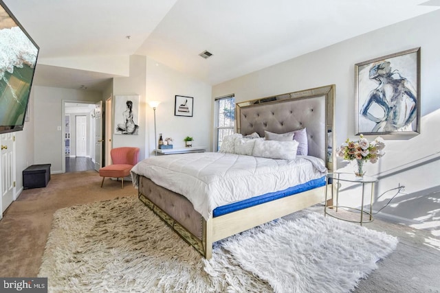 bedroom with lofted ceiling, baseboards, visible vents, and carpet floors