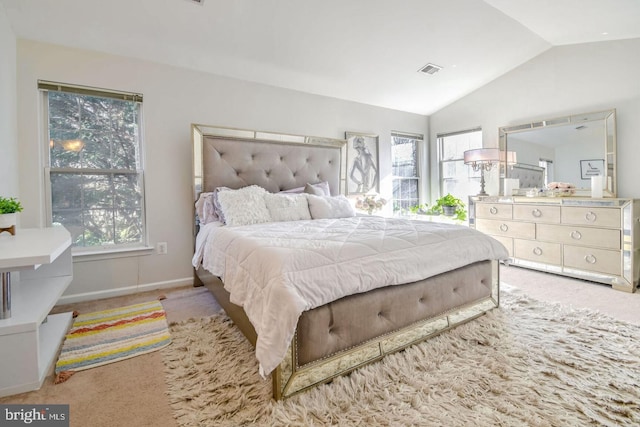 carpeted bedroom featuring vaulted ceiling, multiple windows, baseboards, and visible vents