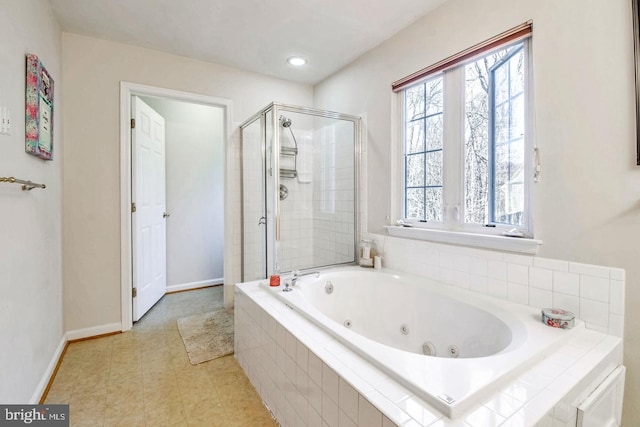 full bathroom featuring a shower stall, baseboards, and a whirlpool tub