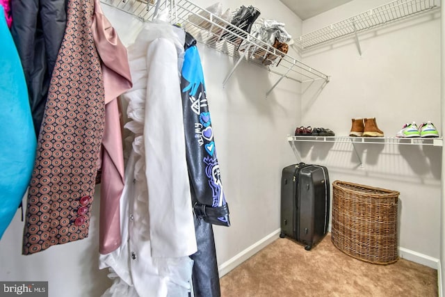 walk in closet with carpet