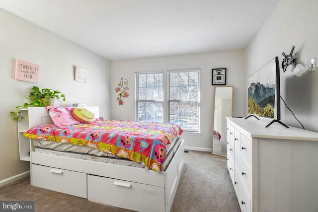 bedroom with light colored carpet and baseboards