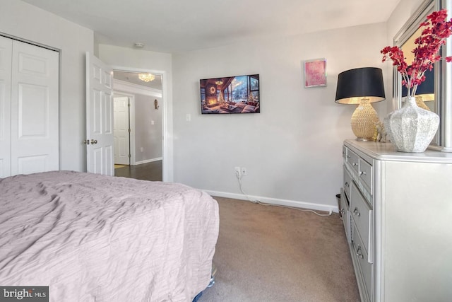 bedroom with a closet, baseboards, and carpet