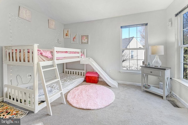 carpeted bedroom featuring baseboards and visible vents