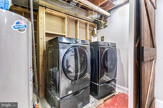 clothes washing area with gas water heater, baseboards, independent washer and dryer, and laundry area