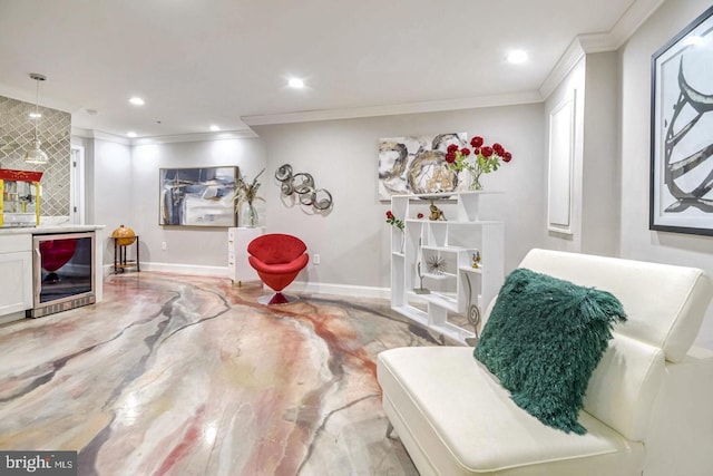 sitting room with recessed lighting, baseboards, beverage cooler, and ornamental molding