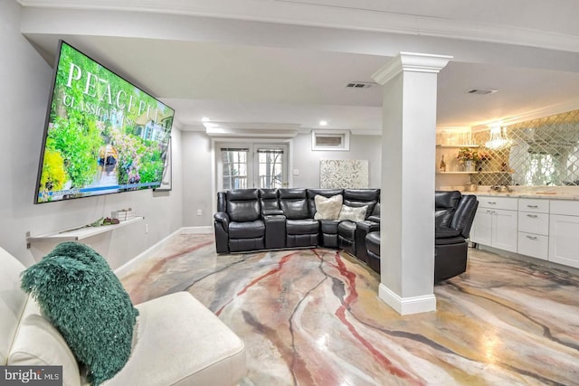 living room featuring visible vents, concrete floors, baseboards, ornamental molding, and decorative columns