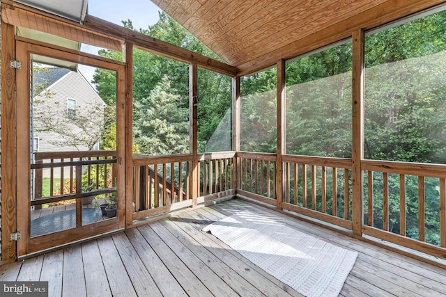 unfurnished sunroom featuring lofted ceiling and wood ceiling