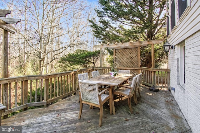 wooden terrace featuring outdoor dining area