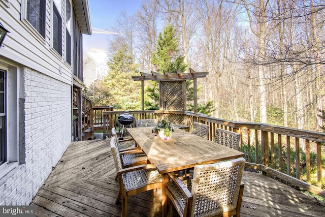 wooden terrace featuring outdoor dining space