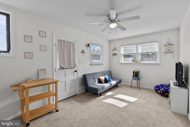 sitting room with carpet flooring, ceiling fan, and baseboards