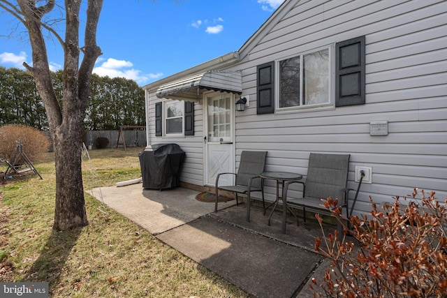 view of patio featuring grilling area and fence