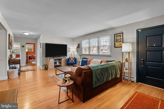 living area featuring light wood-style flooring and a baseboard radiator