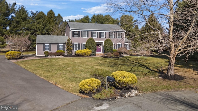 colonial inspired home with a front yard