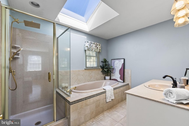 bathroom featuring tile patterned flooring, a garden tub, a skylight, and a stall shower