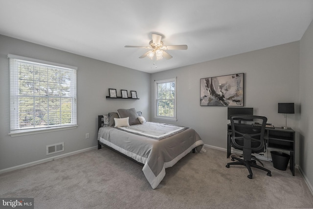 carpeted bedroom featuring visible vents, ceiling fan, and baseboards