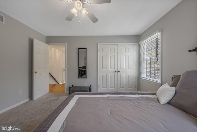 bedroom with a closet, ceiling fan, baseboards, and carpet