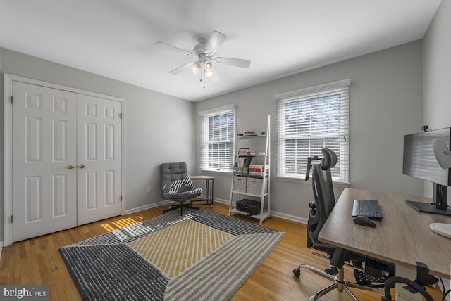 home office with baseboards, wood finished floors, and a ceiling fan