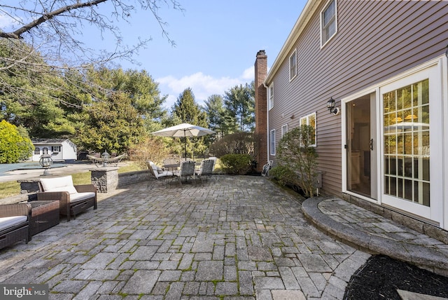 view of patio / terrace with an outbuilding and outdoor dining area