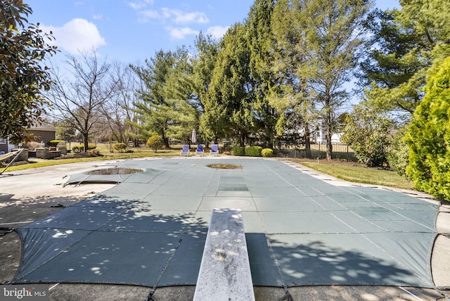 view of pool featuring a patio and fence